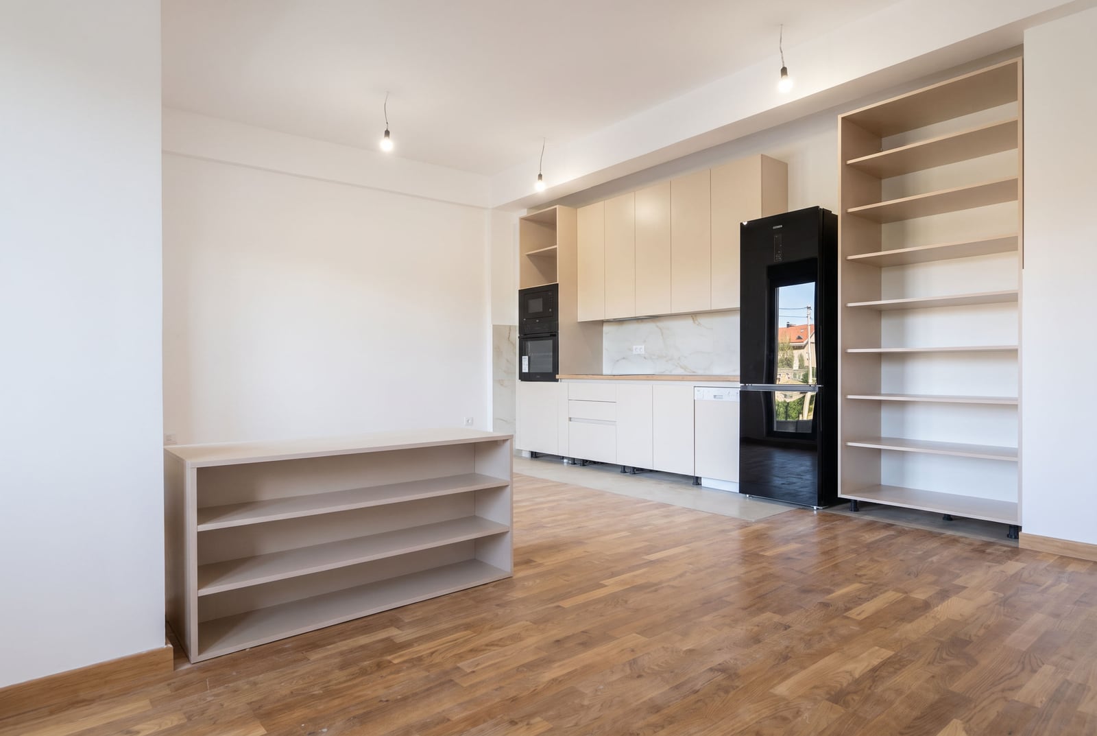 Modern kitchen in an apartment, Bar, Montenegro: light-colored cabinetry, built-in appliances, and open shelving.
