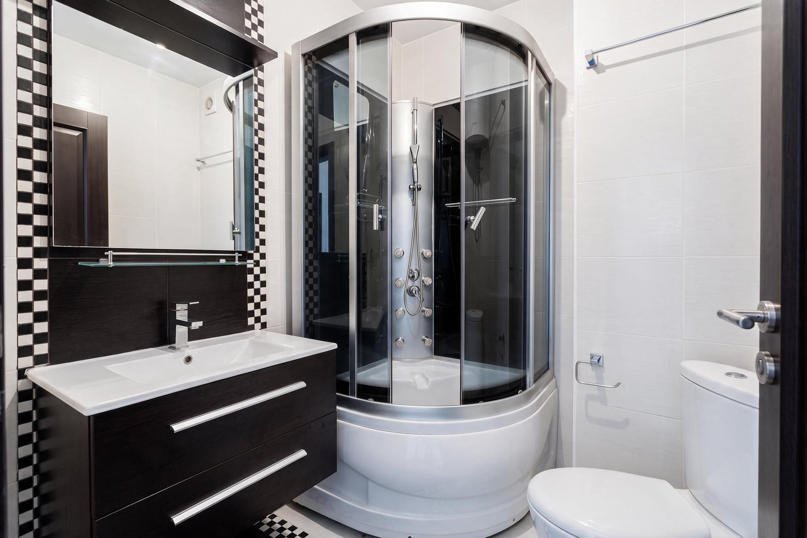 Modern bathroom with a shower cabin, sink, and toilet in an apartment in Petrovac, Montenegro
