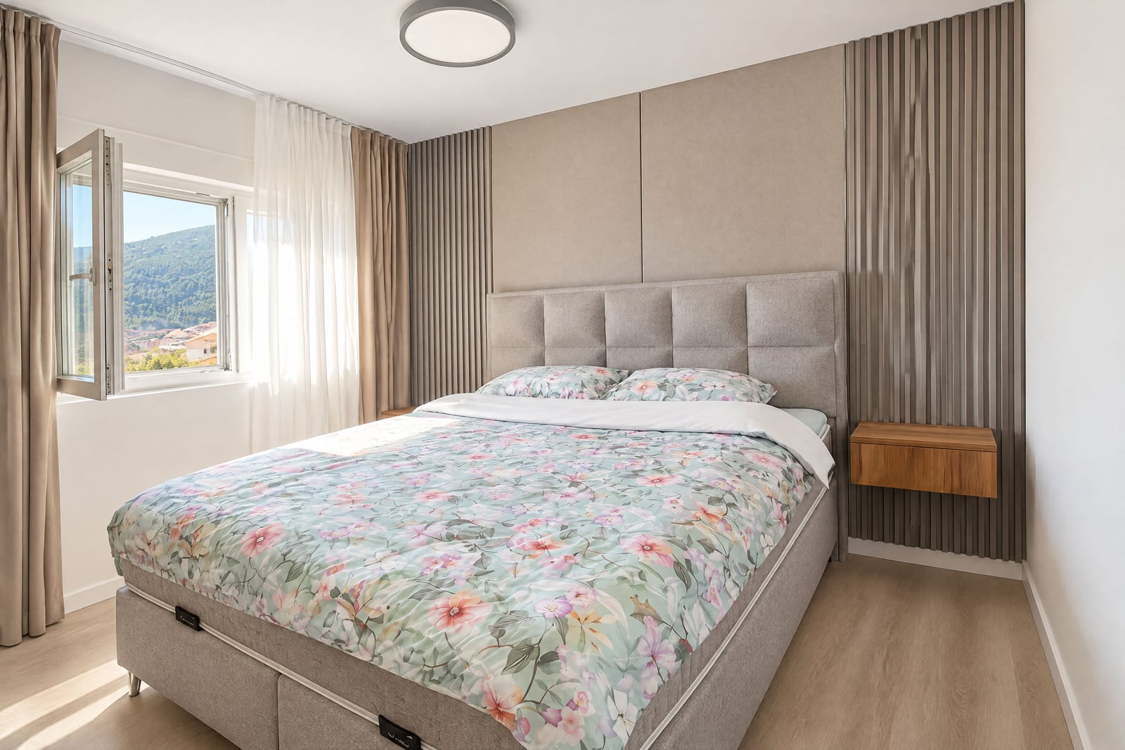 Bedroom with a soft bed, wall panels, and a window with mountain views in an apartment in Budva, Montenegro