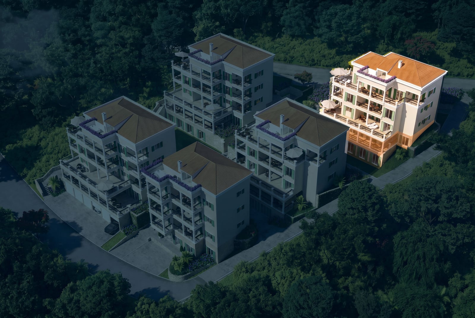 Aerial view of a residential complex in Kumbor, Montenegro: modern multi-story buildings with terraces surrounded by greenery.