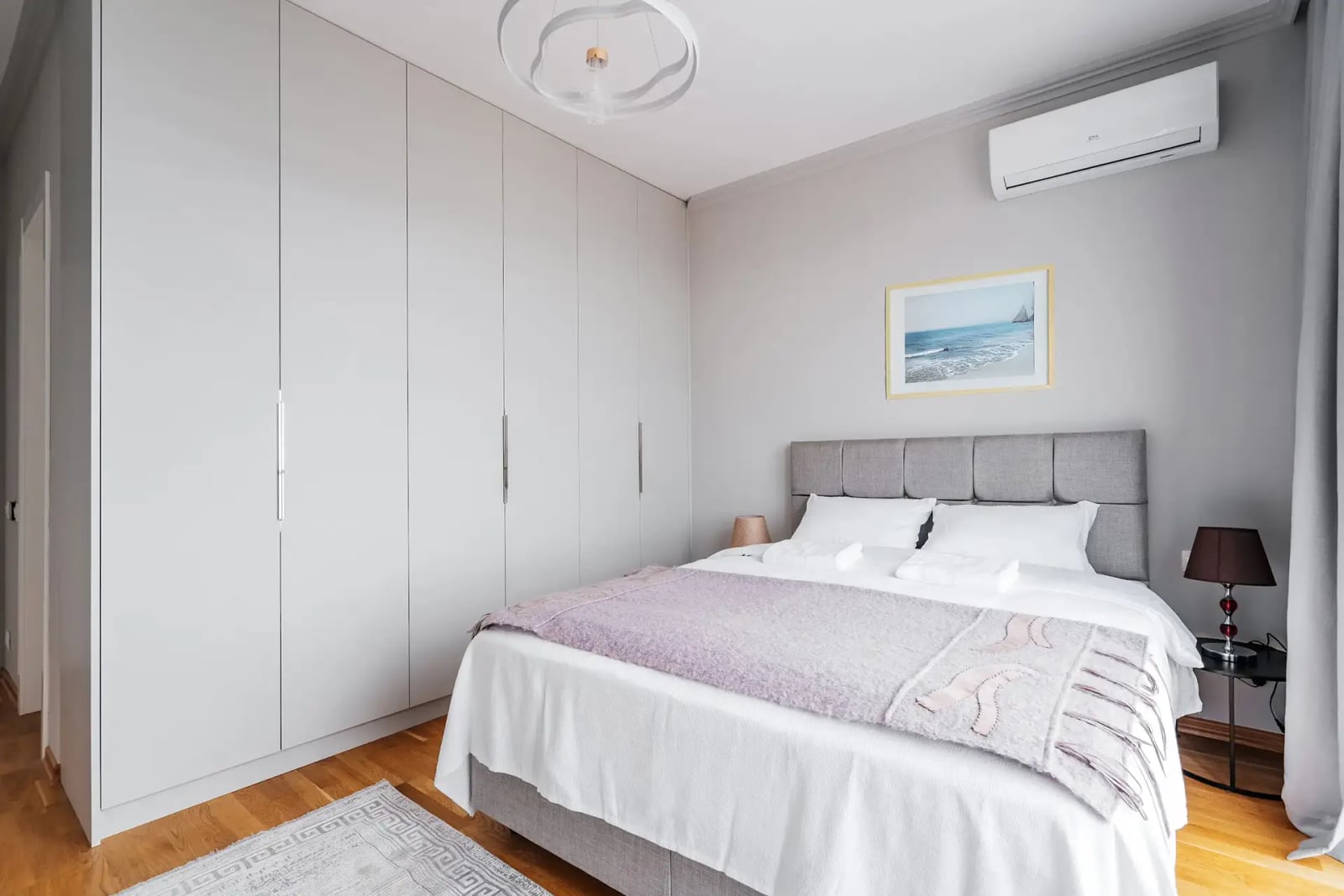 Modern bedroom with a double bed and a built-in wardrobe in a villa in Rezevici, Montenegro.
