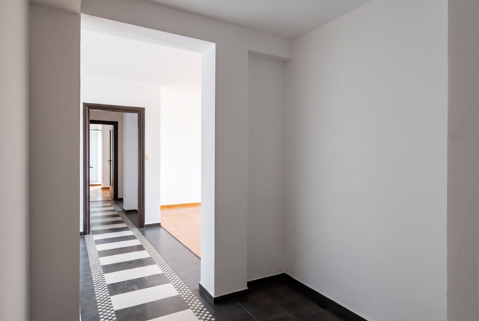 White hallway with black-and-white tile in an apartment for sale in Petrovac, Montenegro.