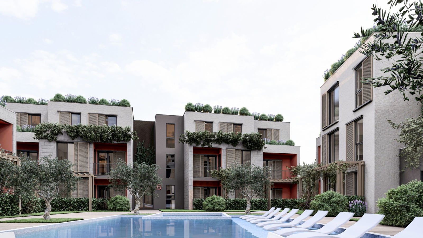 Complexe résidentiel moderne avec piscine et espace détente à Radanovici, Monténégro : vue sur la façade des bâtiments avec aménagement paysager.