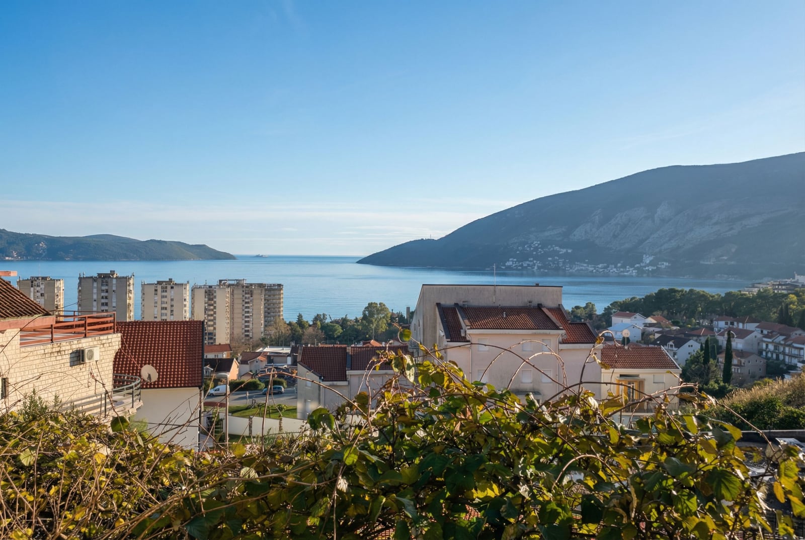 Panoramic view of the sea, mountains, and the town of Igalo from the balcony of an apartment in Montenegro