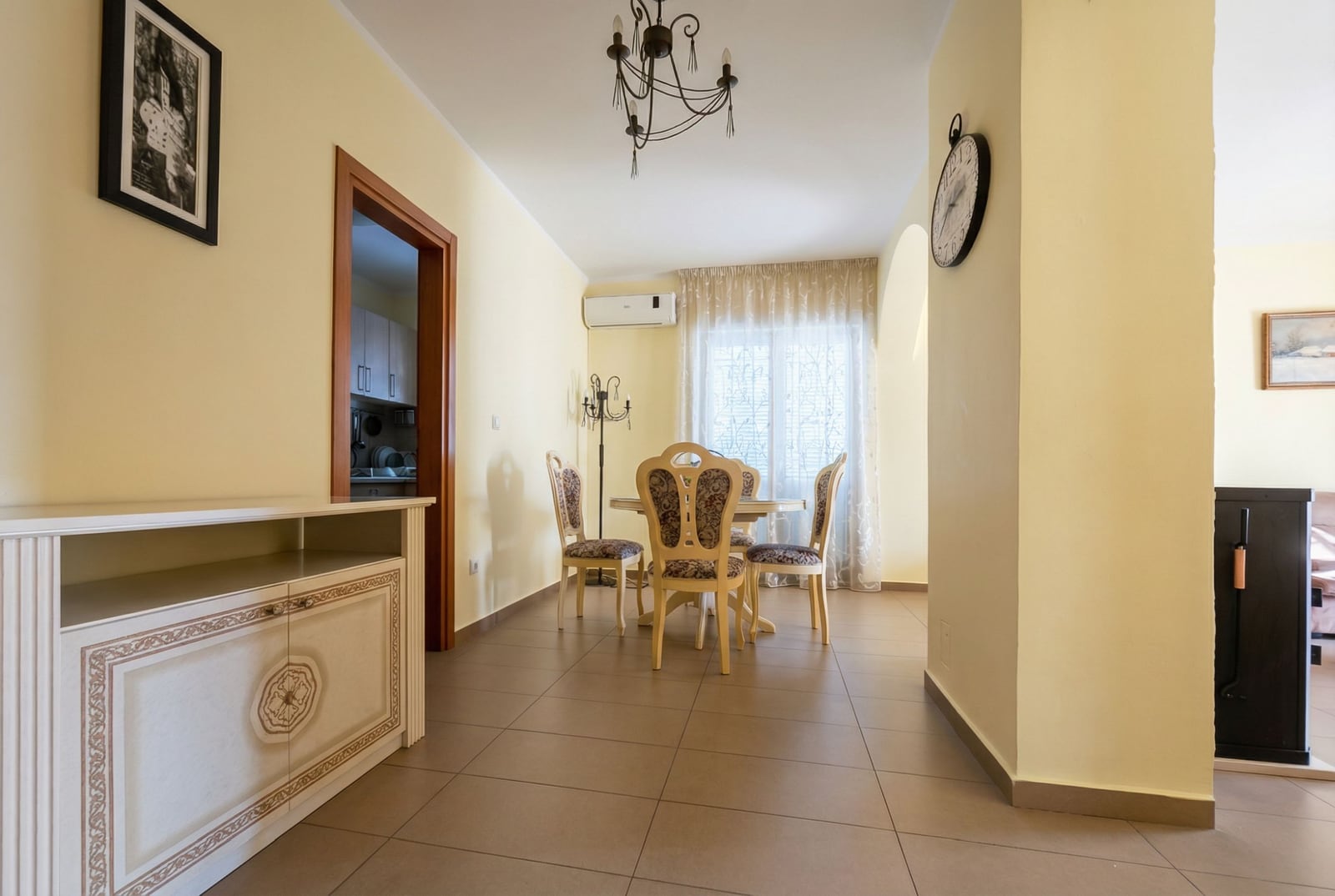 Classic living room with dining area and light-colored furniture in an apartment in Igalo, Montenegro