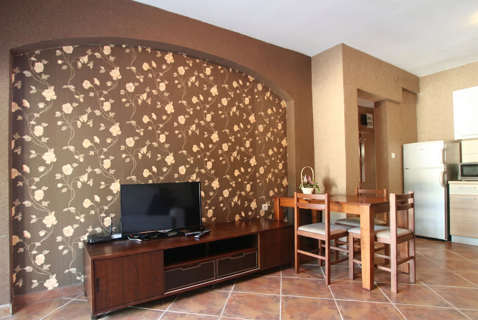 Living room with wooden furniture, TV, and an accent wall in a house in Tivat, Montenegro