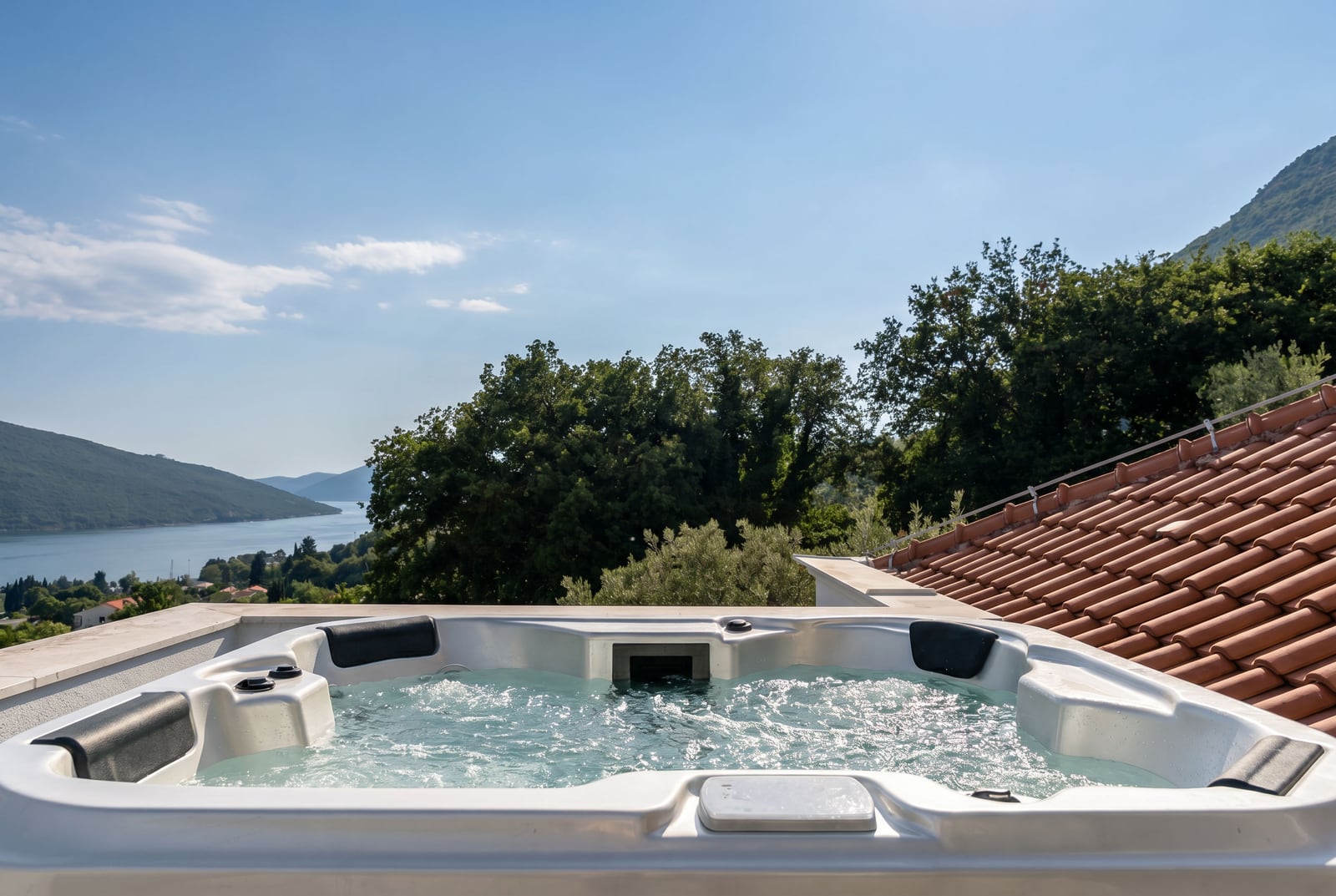Jacuzzi on the penthouse terrace in Kumbor, Montenegro, with panoramic views of the Bay of Kotor and the mountains.