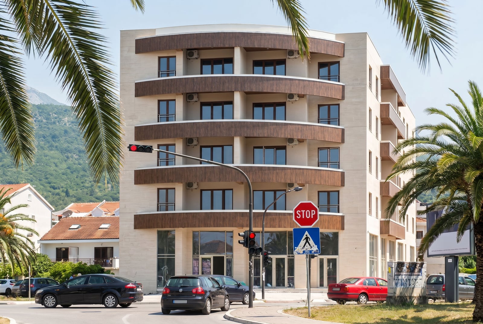 Modern apartment building with panoramic windows and balconies in Budva, Montenegro, street view of the building facade.