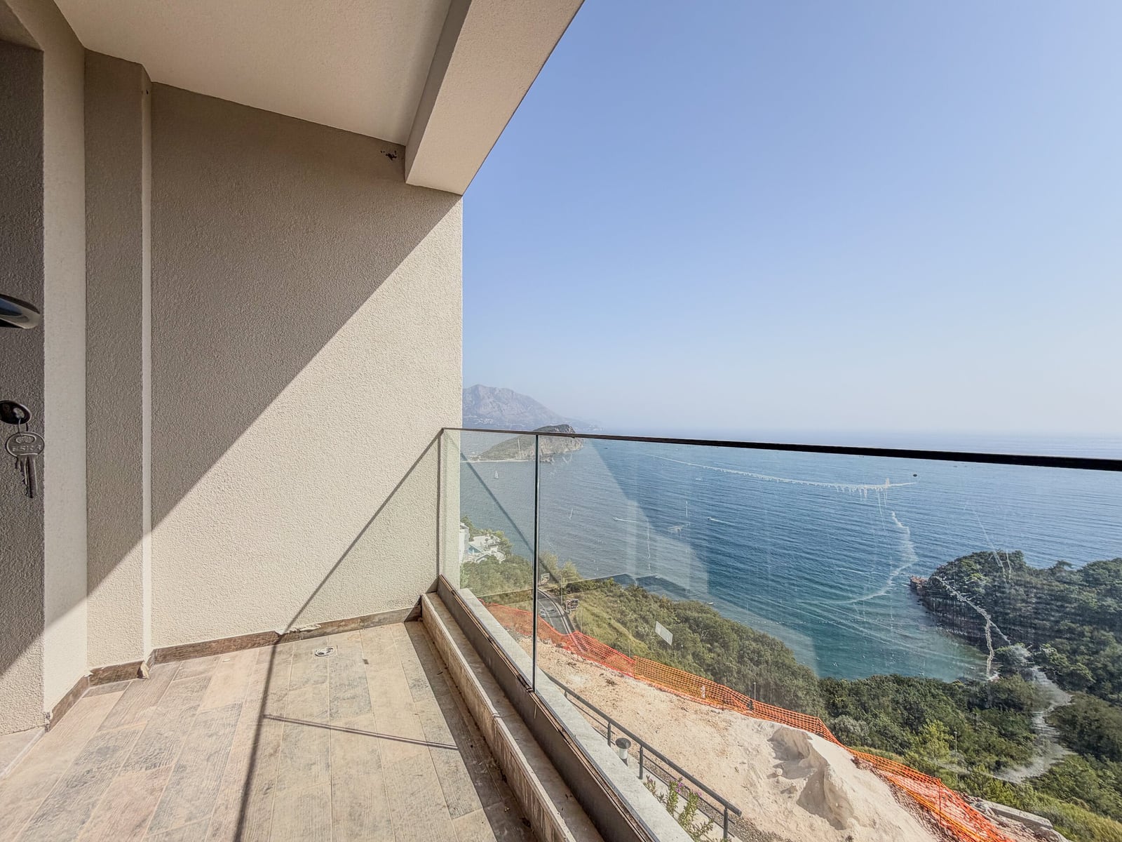 Spacious balcony with panoramic glass railing and sea view in Budva, Montenegro